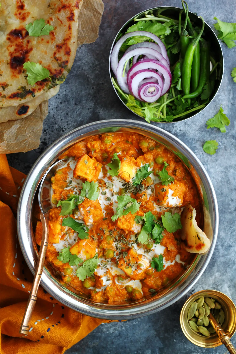 The best Matar Paneer recipe in a bowl with naan and chillies