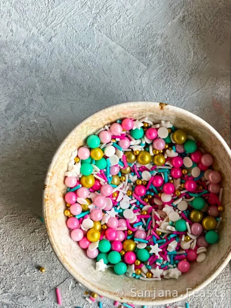 Bowl of sprinkles in pink, blue, green and white