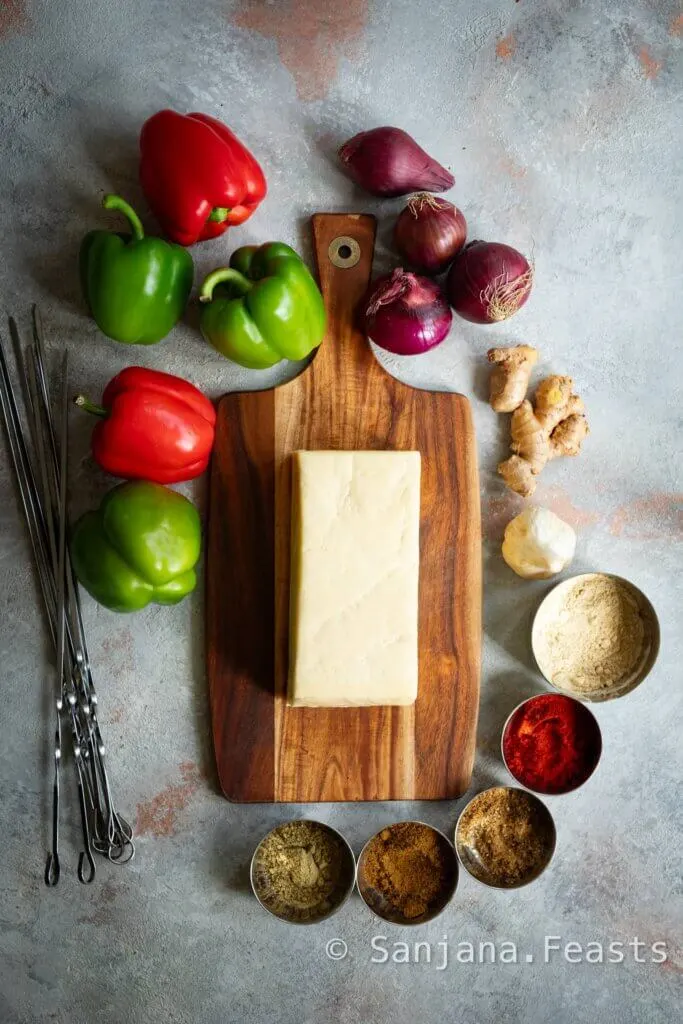 Ingredients for making paneer tikka onions peppers and spices