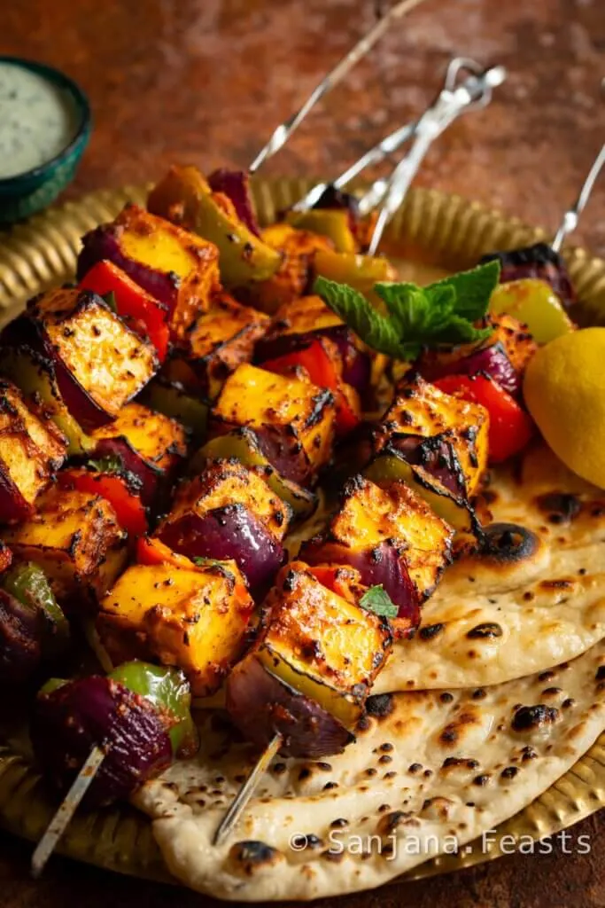 Paneer Tikka Kebab with fresh lemon juice mint yogurt and homemade naan bread