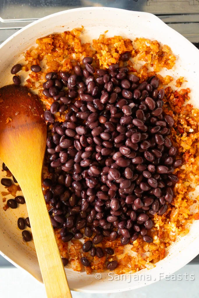Add canned black beans to the spice mixture