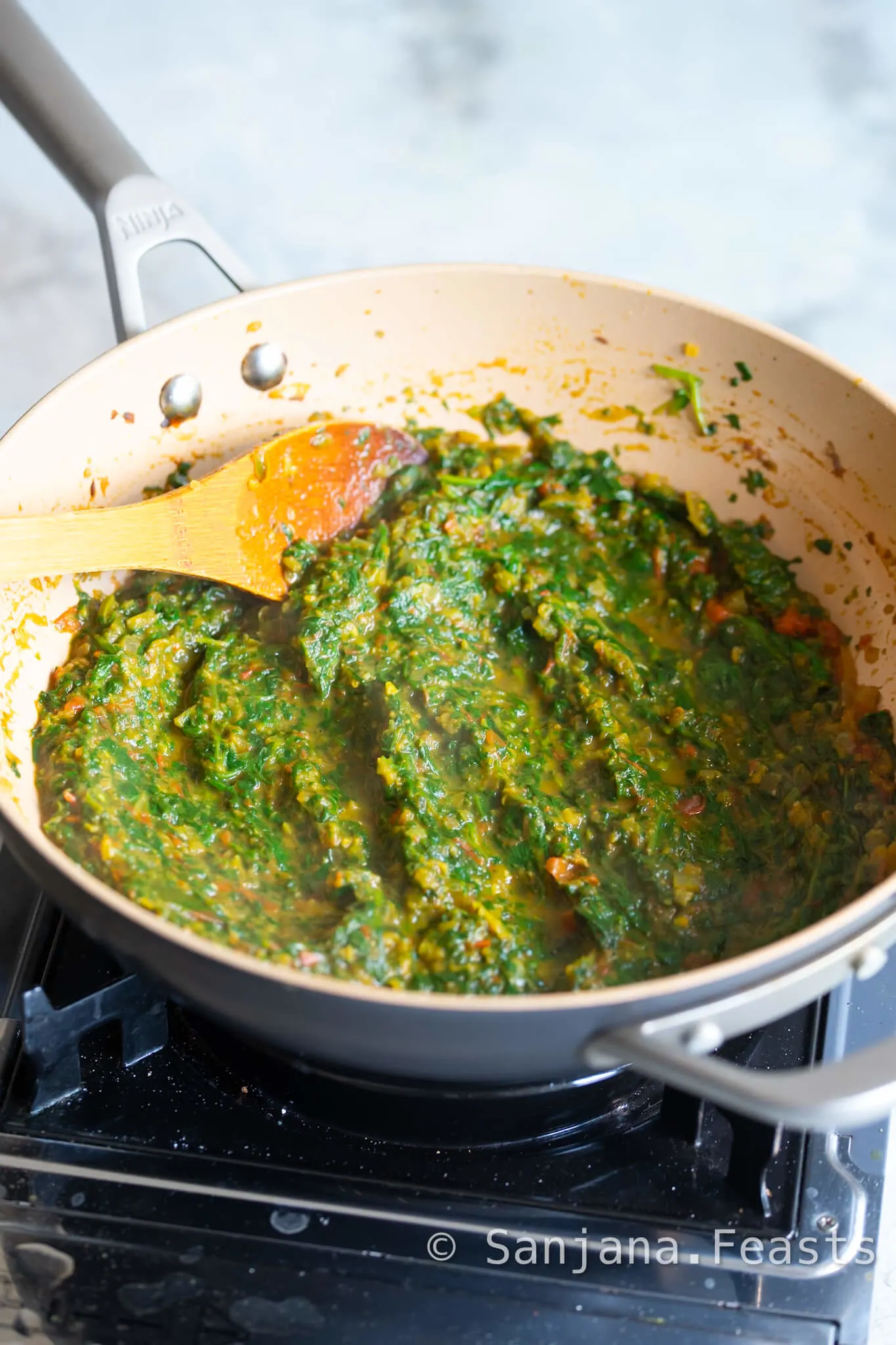 Blend the spinach for a smoother Saag Aloo