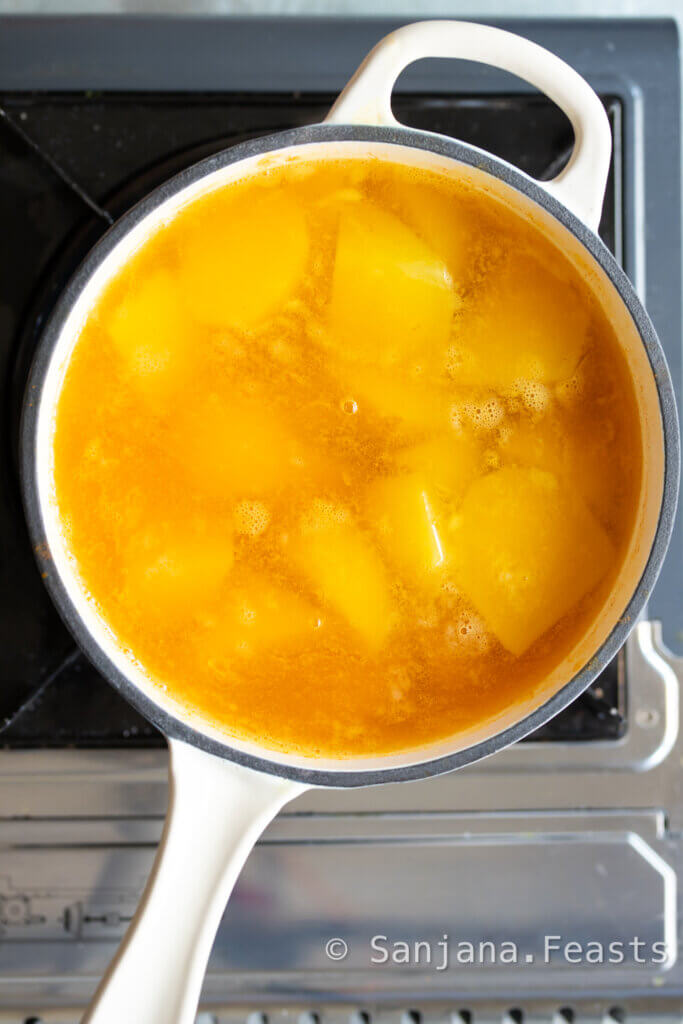 simmer the potatoes in turmeric water