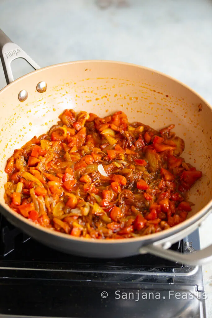 Add tomatoes to the karela curry