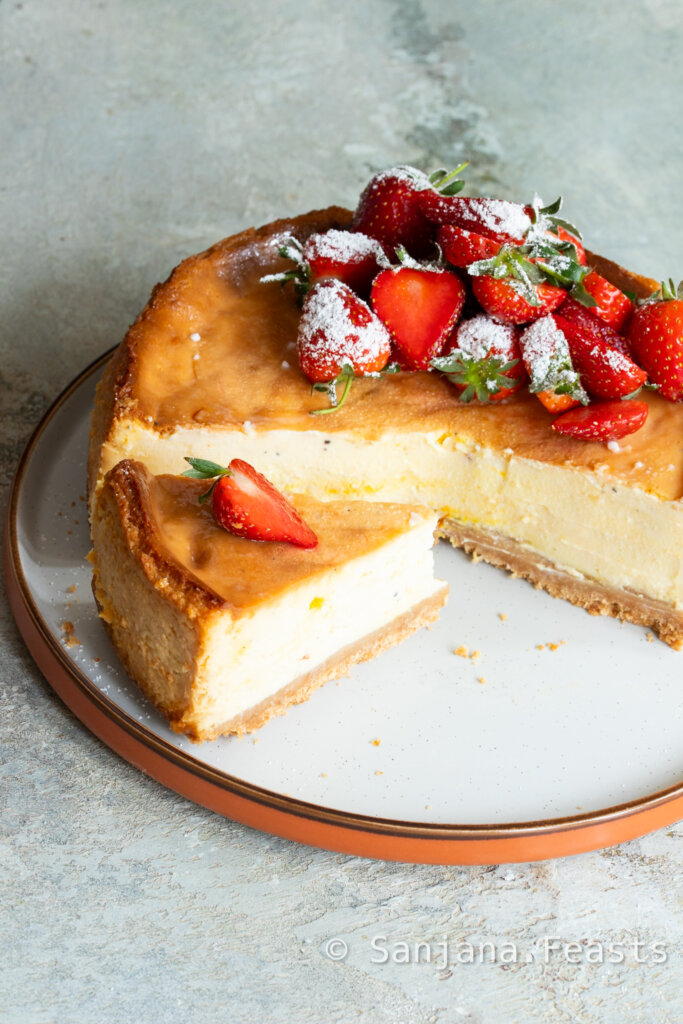 Shrikhand Cheesecake with slice and strawberries on plate