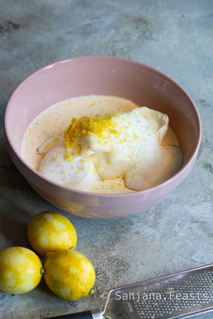 filling for cheesecake in bowl with lemons zested